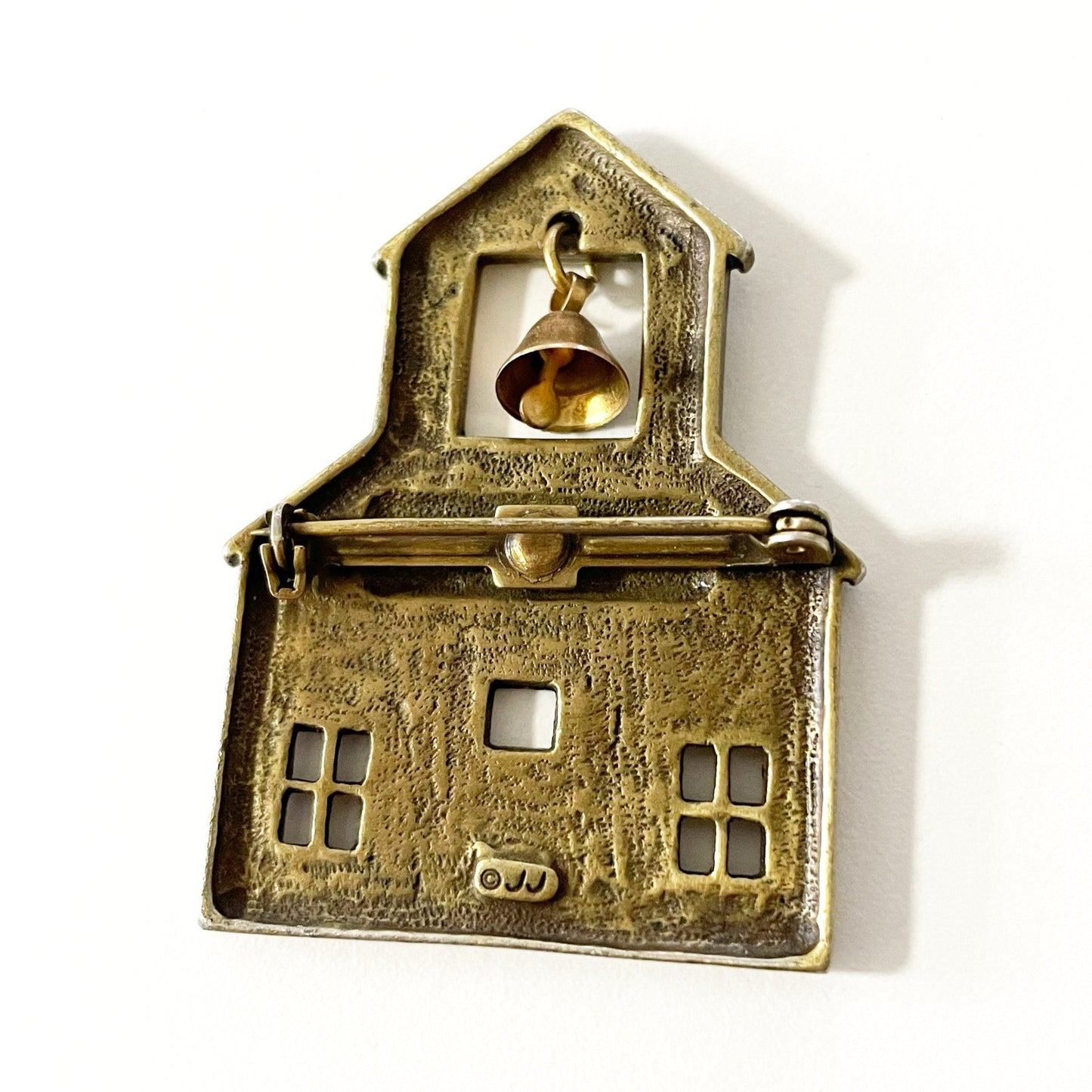 Vintage JJ signed brass tone school brooch with a dangling bell