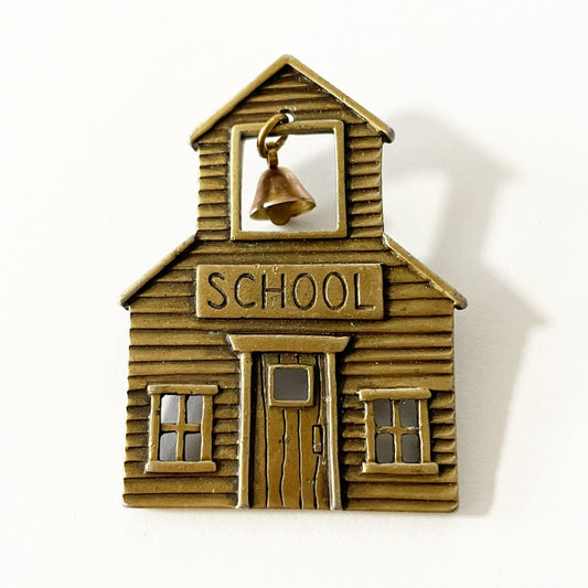 Vintage JJ signed brass tone school brooch with a dangling bell