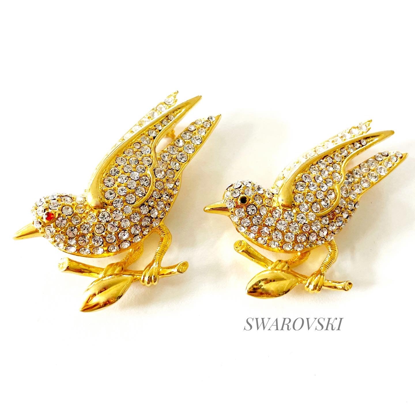 Vintage Swarovski signed swan logo pave crystal bird brooch accented with rudy/sapphire cabochon eye